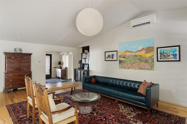 4504 Erin Ln, Austin, TX 78756 - living room with a wall mounted air conditioner, vaulted ceiling, wood finished floors, and baseboards