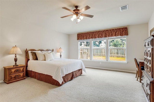 bedroom with light carpet, a ceiling fan, and baseboards
