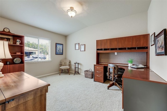 office area with carpet, vaulted ceiling, and baseboards