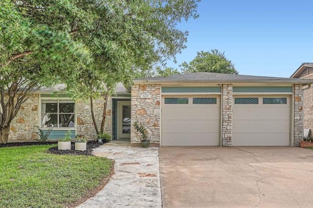 7605 Clydesdale Dr, Austin, TX 78745 - view of front facade with stone siding, a garage, and concrete driveway