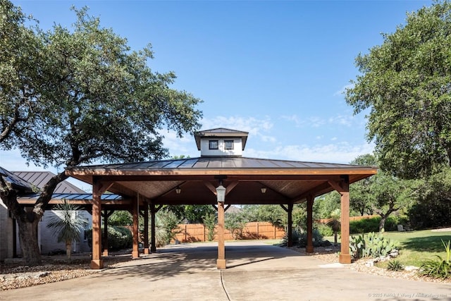 view of home's community featuring a gazebo, driveway, a carport, and fence