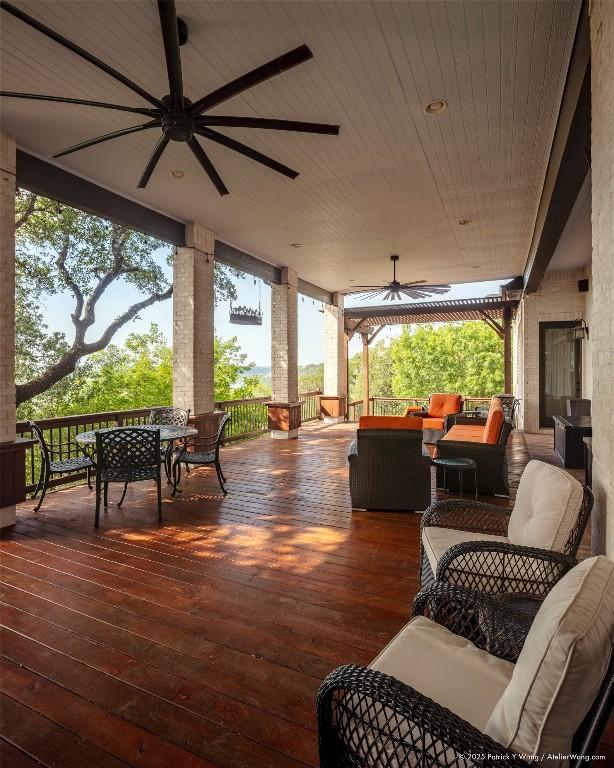 wooden deck with ceiling fan, an outdoor hangout area, and outdoor dining area