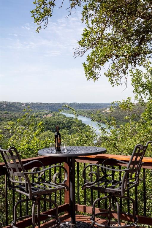 balcony featuring a wooded view