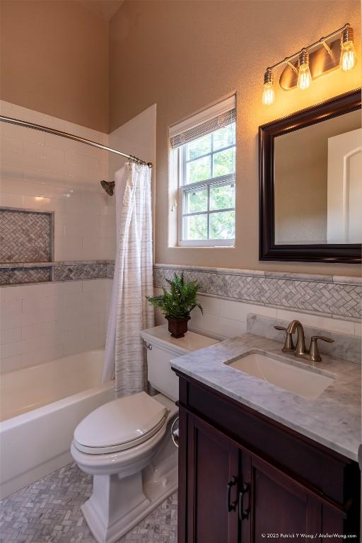 14305 Fallen Timber Dr, Austin, TX 78734 - bathroom featuring vanity, tile walls, shower / tub combo, a wainscoted wall, and tile patterned floors