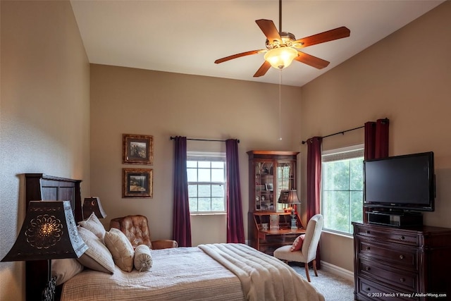 14305 Fallen Timber Dr, Austin, TX 78734 - carpeted bedroom with multiple windows, baseboards, high vaulted ceiling, and ceiling fan