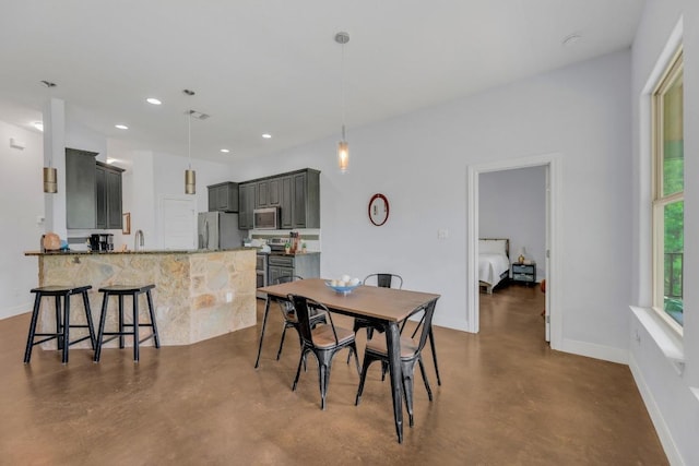 265 Makaha Dr, Bastrop, TX 78602 - dining room featuring finished concrete flooring, baseboards, and recessed lighting