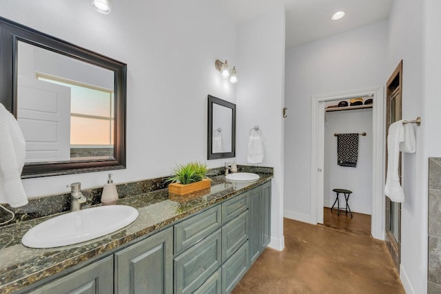 265 Makaha Dr, Bastrop, TX 78602 - bathroom with double vanity, concrete floors, and baseboards
