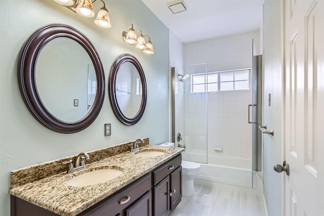 103 Savin Rise Ct, Pflugerville, TX 78660 - full bath featuring double vanity, toilet, and combined bath / shower with glass door