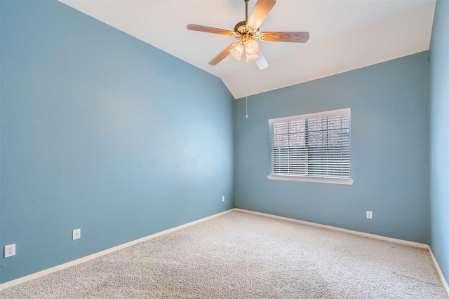 carpeted spare room with baseboards, ceiling fan, and vaulted ceiling