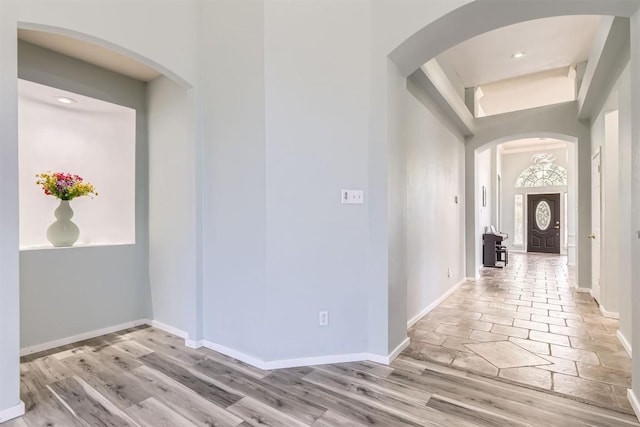 103 Savin Rise Ct, Pflugerville, TX 78660 - corridor with arched walkways, baseboards, recessed lighting, and stone tile floors