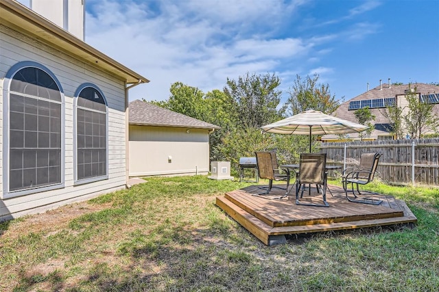 view of yard with a deck and outdoor dining space