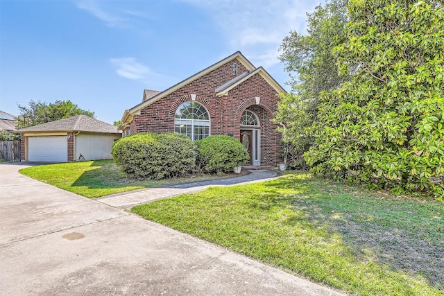 103 Savin Rise Ct, Pflugerville, TX 78660 - view of front of property with brick siding, a front lawn, a garage, and driveway