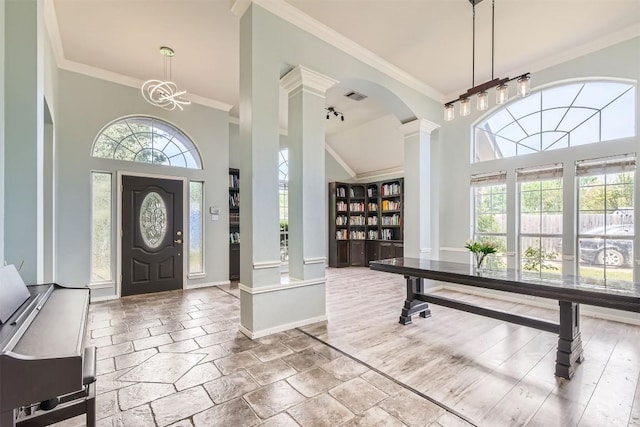 103 Savin Rise Ct, Pflugerville, TX 78660 - entryway featuring ornamental molding, ornate columns, a high ceiling, baseboards, and stone tile floors