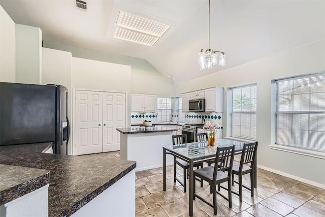 103 Savin Rise Ct, Pflugerville, TX 78660 - dining area with a chandelier, plenty of natural light, vaulted ceiling, and baseboards