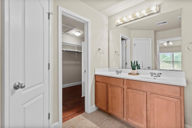 full bathroom featuring double vanity, tile patterned floors, a spacious closet, and ceiling fan