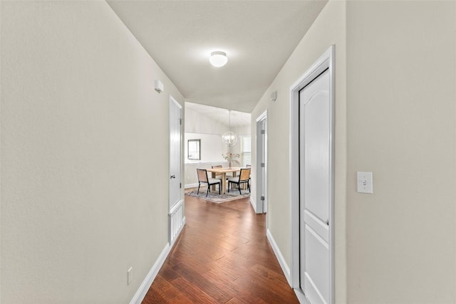 hallway with wood finished floors and baseboards