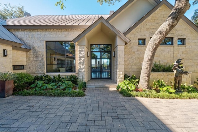 6605 W Courtyard Dr, Austin, TX 78730 - doorway to property with a standing seam roof, stone siding, a metal roof, and french doors