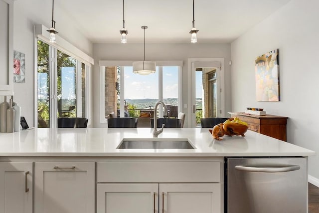 6605 W Courtyard Dr, Austin, TX 78730 - kitchen featuring a sink, dishwasher, light countertops, and white cabinetry