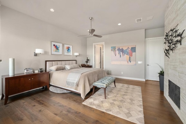 6605 W Courtyard Dr, Austin, TX 78730 - bedroom featuring wood finished floors, recessed lighting, a tile fireplace, baseboards, and ceiling fan