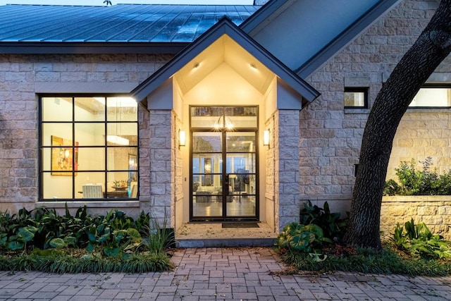 6605 W Courtyard Dr, Austin, TX 78730 - property entrance featuring stone siding, a standing seam roof, and a metal roof