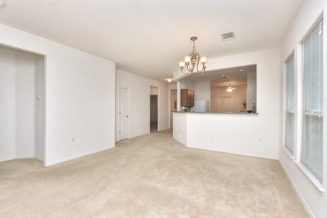 221 Bonham Loop, Georgetown, TX 78633 - unfurnished living room with a chandelier, light carpet, and baseboards