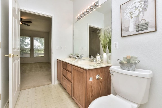 221 Bonham Loop, Georgetown, TX 78633 - bathroom with toilet, tile patterned floors, double vanity, and ceiling fan