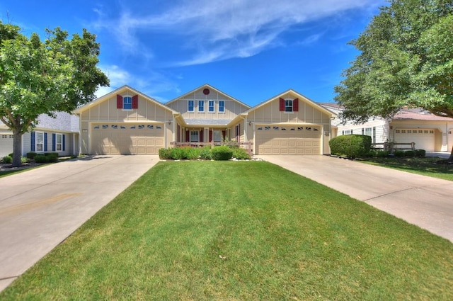 221 Bonham Loop, Georgetown, TX 78633 - view of front facade with board and batten siding, concrete driveway, a front yard, and a garage