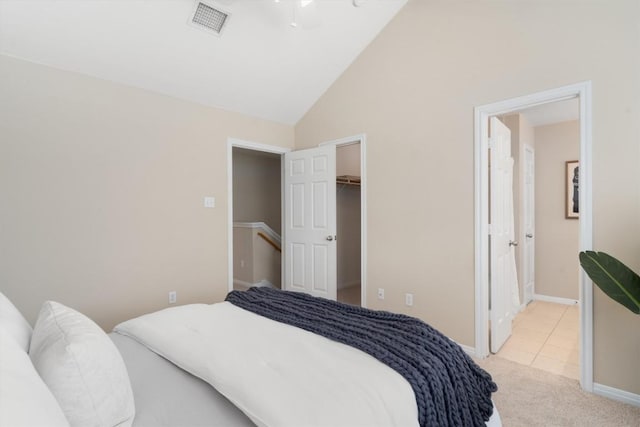 401 Buttercup Creek Blvd Unit 1005, Cedar Park, TX 78613 - carpeted bedroom featuring lofted ceiling, a walk in closet, baseboards, tile patterned flooring, and a closet
