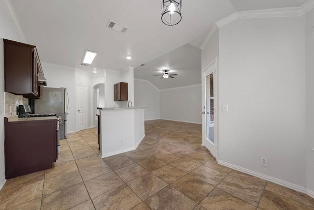 118 Cassandra Dr, Hutto, TX 78634 - kitchen with vaulted ceiling, arched walkways, dark brown cabinetry, crown molding, and light countertops