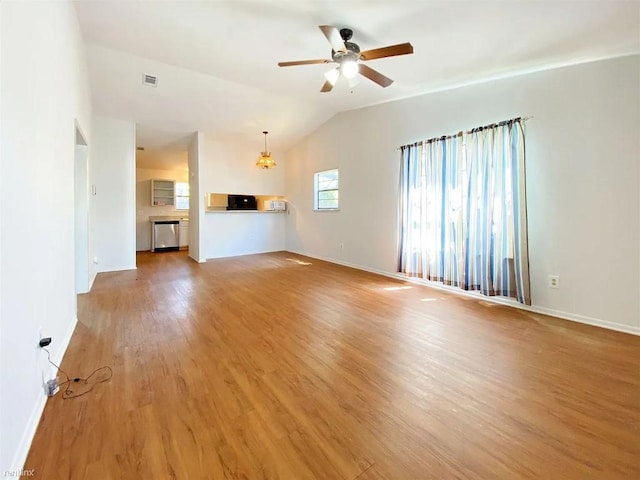 1604 Mill St Unit B, San Marcos, TX 78666 - unfurnished living room with a ceiling fan, light wood-type flooring, baseboards, a chandelier, and vaulted ceiling