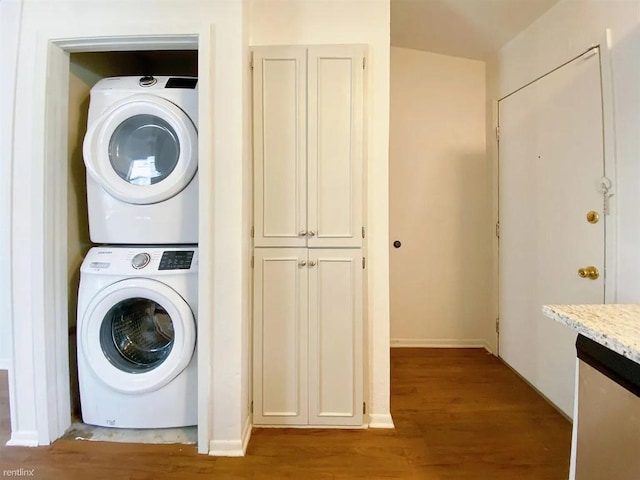 1604 Mill St Unit B, San Marcos, TX 78666 - laundry room with stacked washer and clothes dryer and wood finished floors