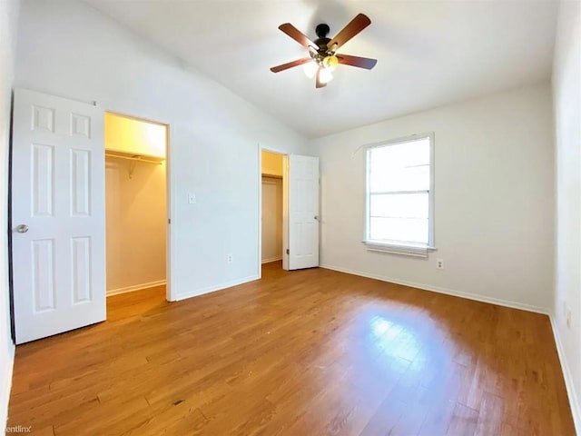 1604 Mill St Unit B, San Marcos, TX 78666 - unfurnished bedroom with lofted ceiling, baseboards, light wood-type flooring, and ceiling fan