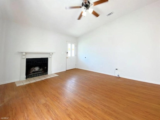 1604 Mill St Unit B, San Marcos, TX 78666 - unfurnished living room with a fireplace, a ceiling fan, light wood-style flooring, and lofted ceiling