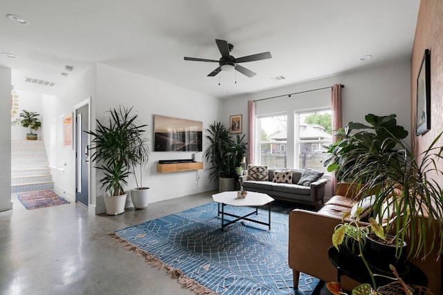 living area with concrete flooring, ceiling fan, baseboards, and recessed lighting