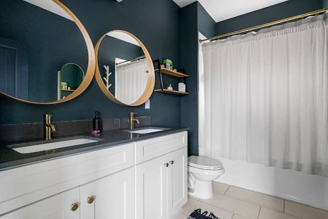 bathroom featuring tile patterned floors, toilet, double vanity, and shower / bath combo with shower curtain
