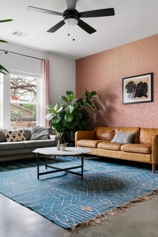 2912 Govalle Ave Unit A, Austin, TX 78702 - living room with a ceiling fan, a textured wall, and concrete flooring