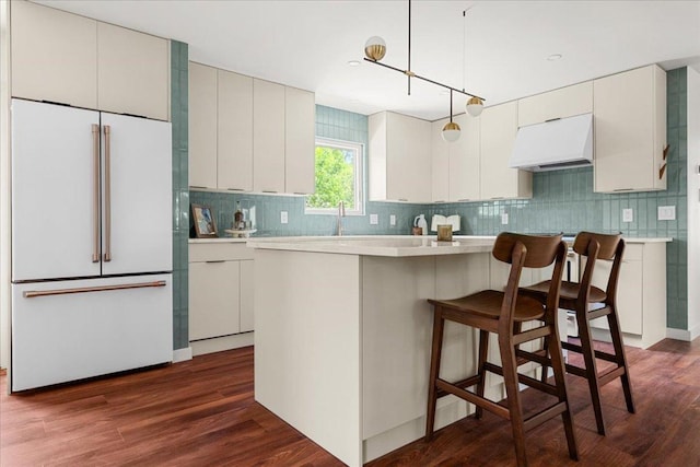 3605 Tallison Ter, Austin, TX 78704 - kitchen with high end white refrigerator, under cabinet range hood, backsplash, and light countertops