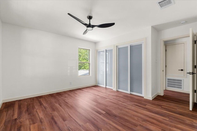 3605 Tallison Ter, Austin, TX 78704 - unfurnished bedroom with multiple closets, wood finished floors, and a ceiling fan