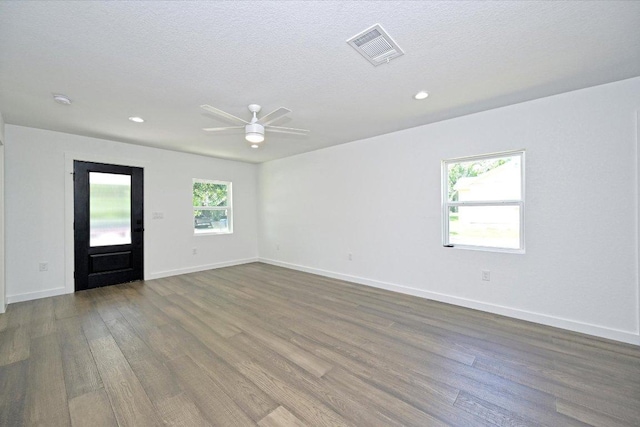 710 E 2nd St, Elgin, TX 78621 - unfurnished room with wood finished floors, a ceiling fan, a textured ceiling, recessed lighting, and a smoke detector