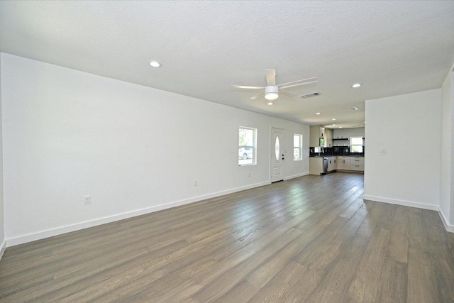 710 E 2nd St, Elgin, TX 78621 - unfurnished living room with a ceiling fan, dark wood-style flooring, and recessed lighting
