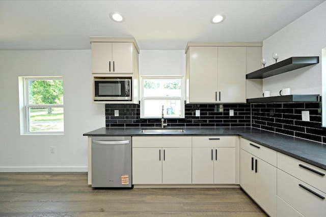 710 E 2nd St, Elgin, TX 78621 - kitchen featuring stainless steel appliances, open shelves, dark countertops, light wood finished floors, and recessed lighting