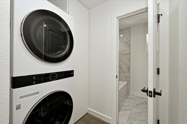 710 E 2nd St, Elgin, TX 78621 - laundry area with estacked washer and dryer and light marble finish flooring