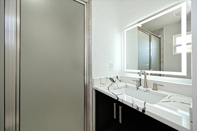 710 E 2nd St, Elgin, TX 78621 - bathroom featuring vanity and a shower stall