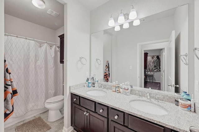 110 N Sage Holw, Dripping Springs, TX 78620 - bathroom with double vanity and toilet