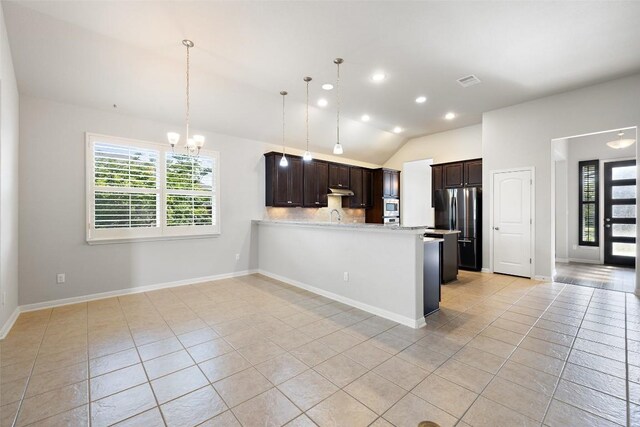 110 N Sage Holw, Dripping Springs, TX 78620 - kitchen featuring appliances with stainless steel finishes, light tile patterned floors, plenty of natural light, a chandelier, and lofted ceiling