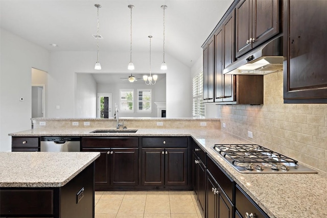 110 N Sage Holw, Dripping Springs, TX 78620 - kitchen featuring appliances with stainless steel finishes, lofted ceiling, under cabinet range hood, decorative backsplash, and light tile patterned flooring
