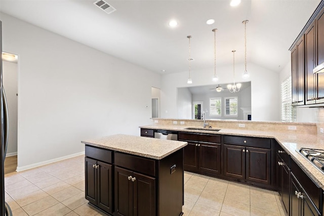 110 N Sage Holw, Dripping Springs, TX 78620 - kitchen with light tile patterned floors, vaulted ceiling, backsplash, and a peninsula