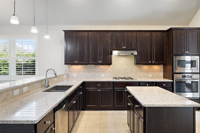 110 N Sage Holw, Dripping Springs, TX 78620 - kitchen with appliances with stainless steel finishes, tasteful backsplash, light tile patterned floors, and light stone countertops