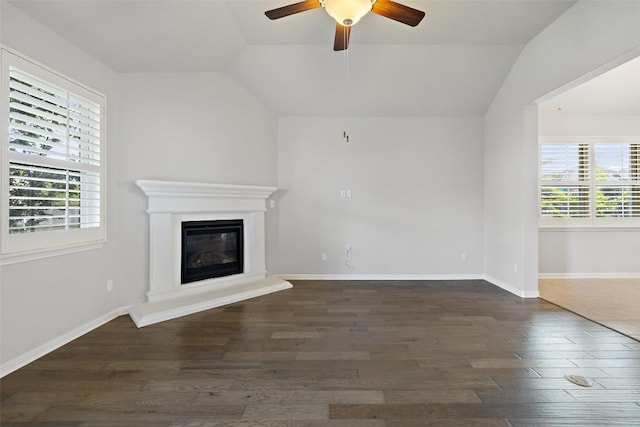 110 N Sage Holw, Dripping Springs, TX 78620 - unfurnished living room with vaulted ceiling, wood finished floors, ceiling fan, and a glass covered fireplace
