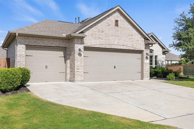 110 N Sage Holw, Dripping Springs, TX 78620 - view of front of property featuring a garage, concrete driveway, roof with shingles, and stone siding